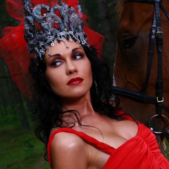 Photo session of beautiful woman in red dress with brown horse in the vesuvius national park