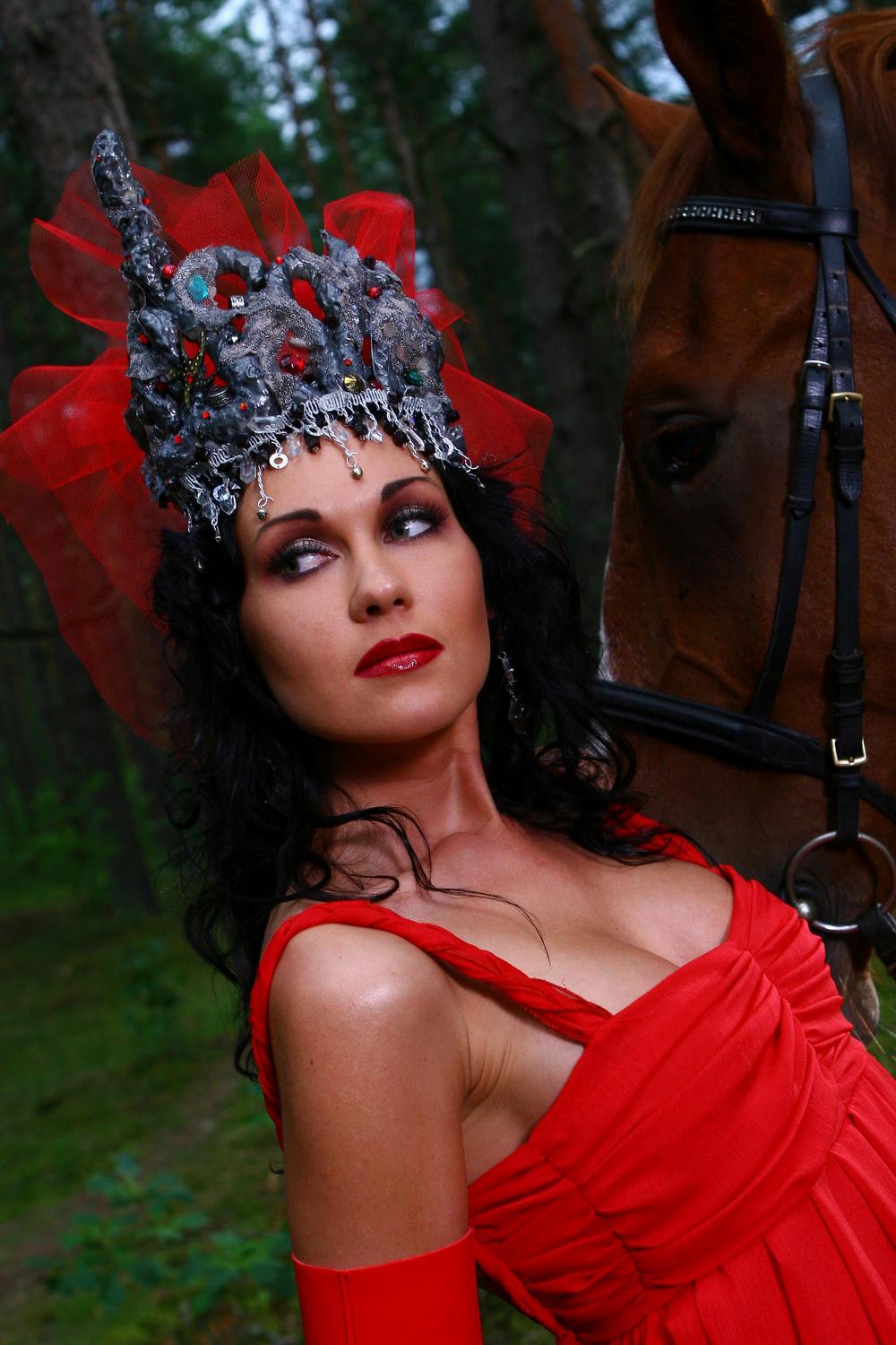 Photo session of beautiful woman in red dress with brown horse in the vesuvius national park